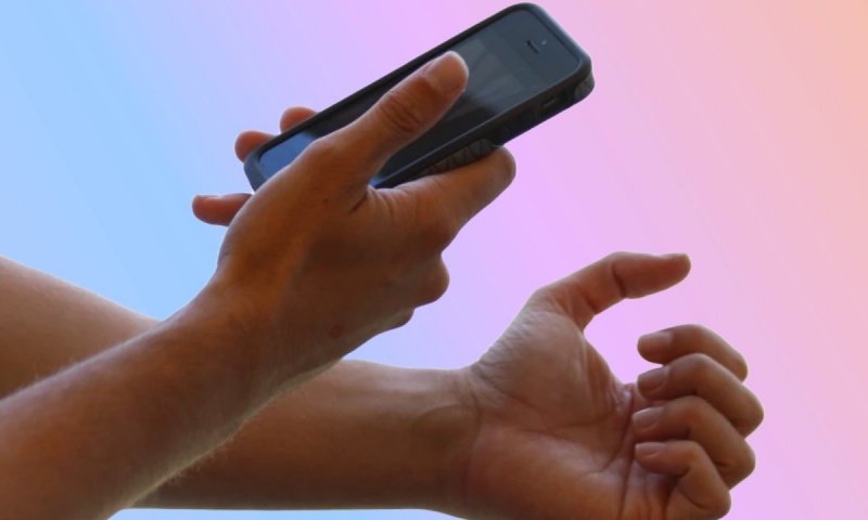 Person clicking picture of their nails.
